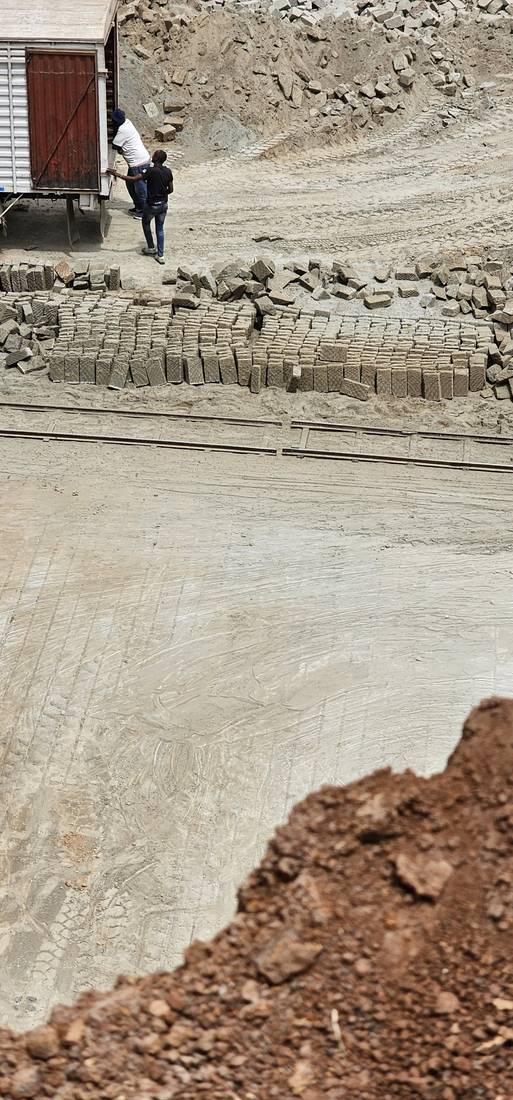 Workers loading cut Ndarugo stone onto a delivery truck