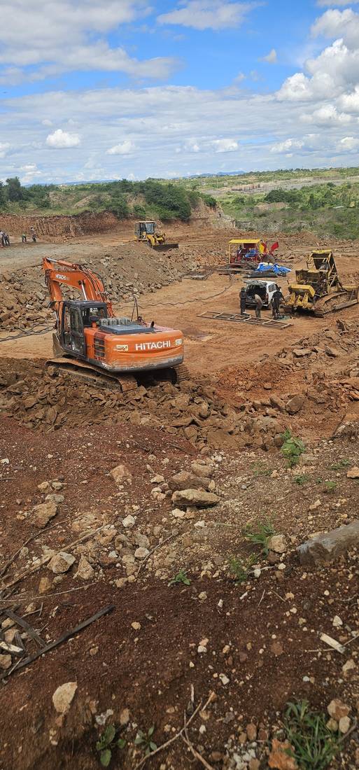 Wide view of the quarry with excavator and bulldozer